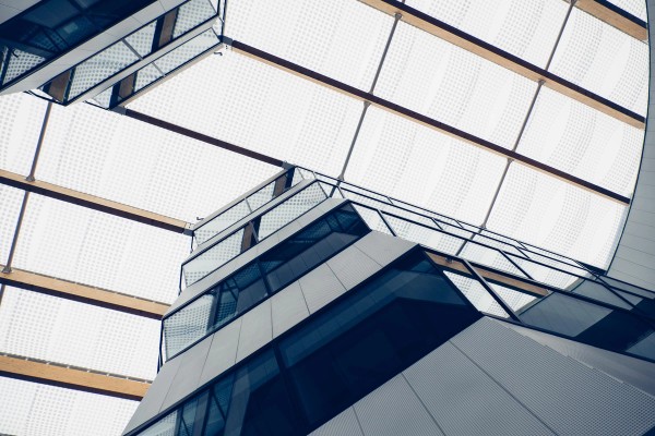 Looking up at geometric buildings facing each other with a skylight