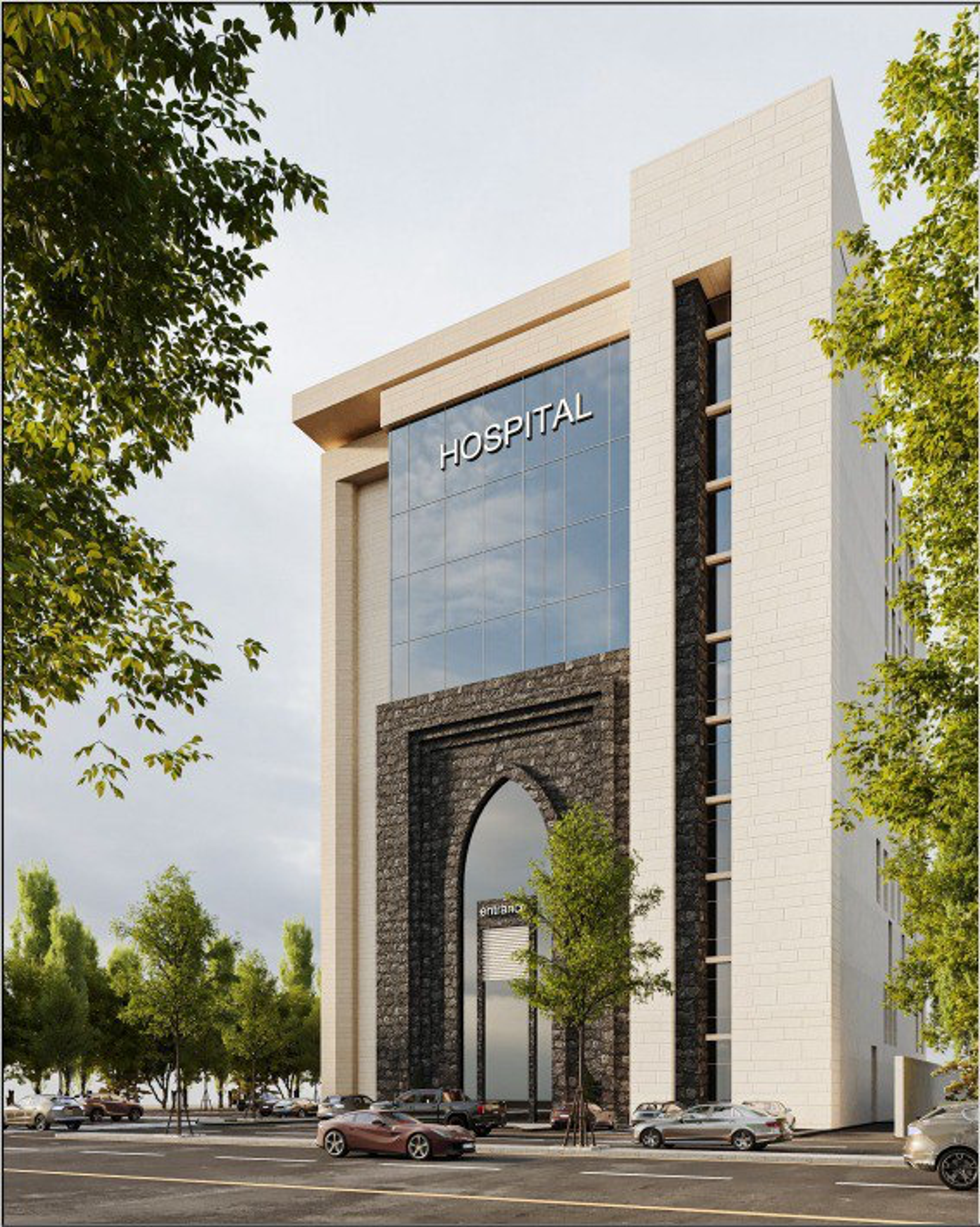 منظور خارجي لمبنى مستشفى العطير الخيري بواجهته الزجاجية ومدخله المقوّس المكسو بالحجر الداكن