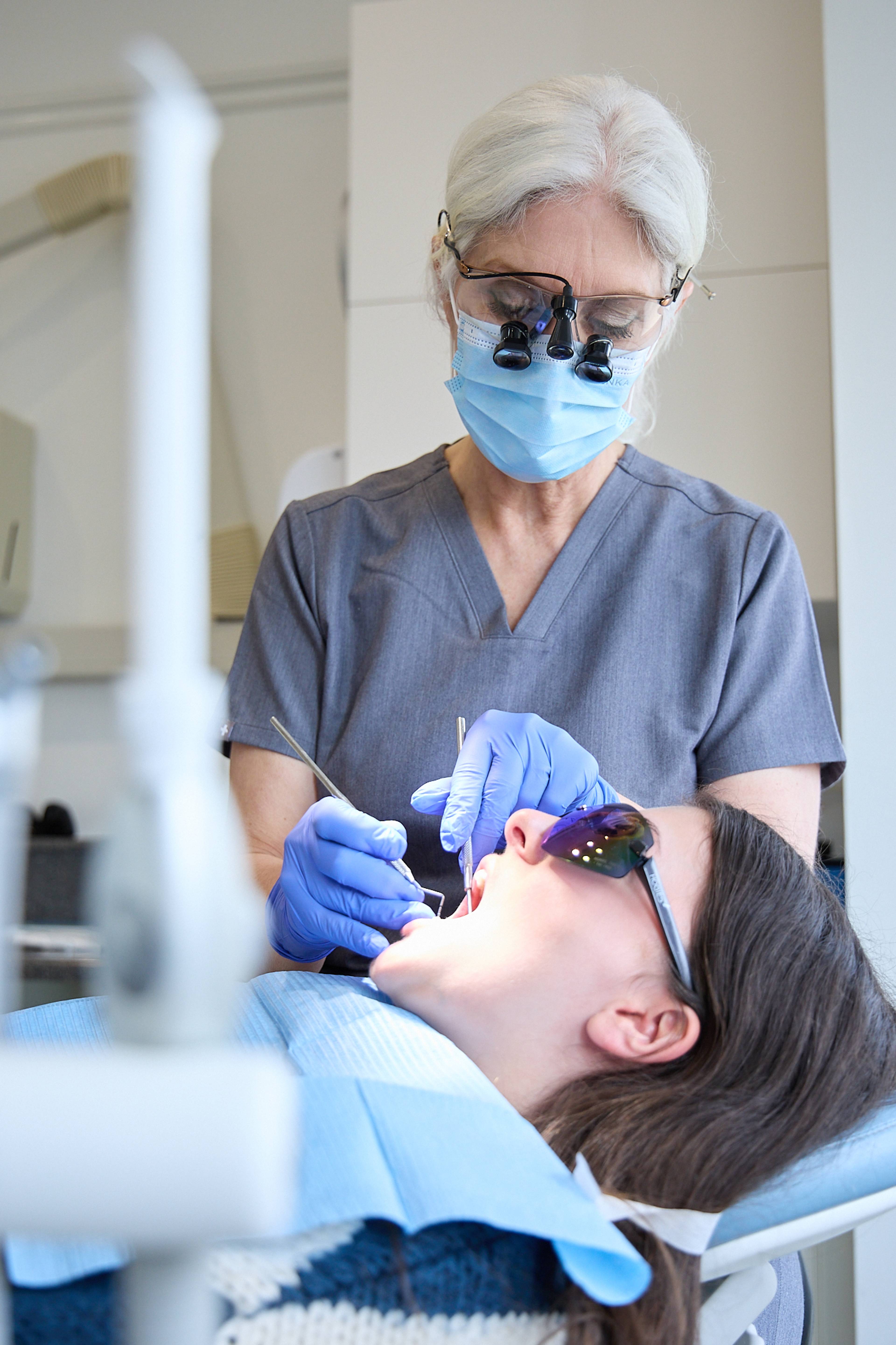 Dental hygienist Cathy Barber cleans a patient's teeth