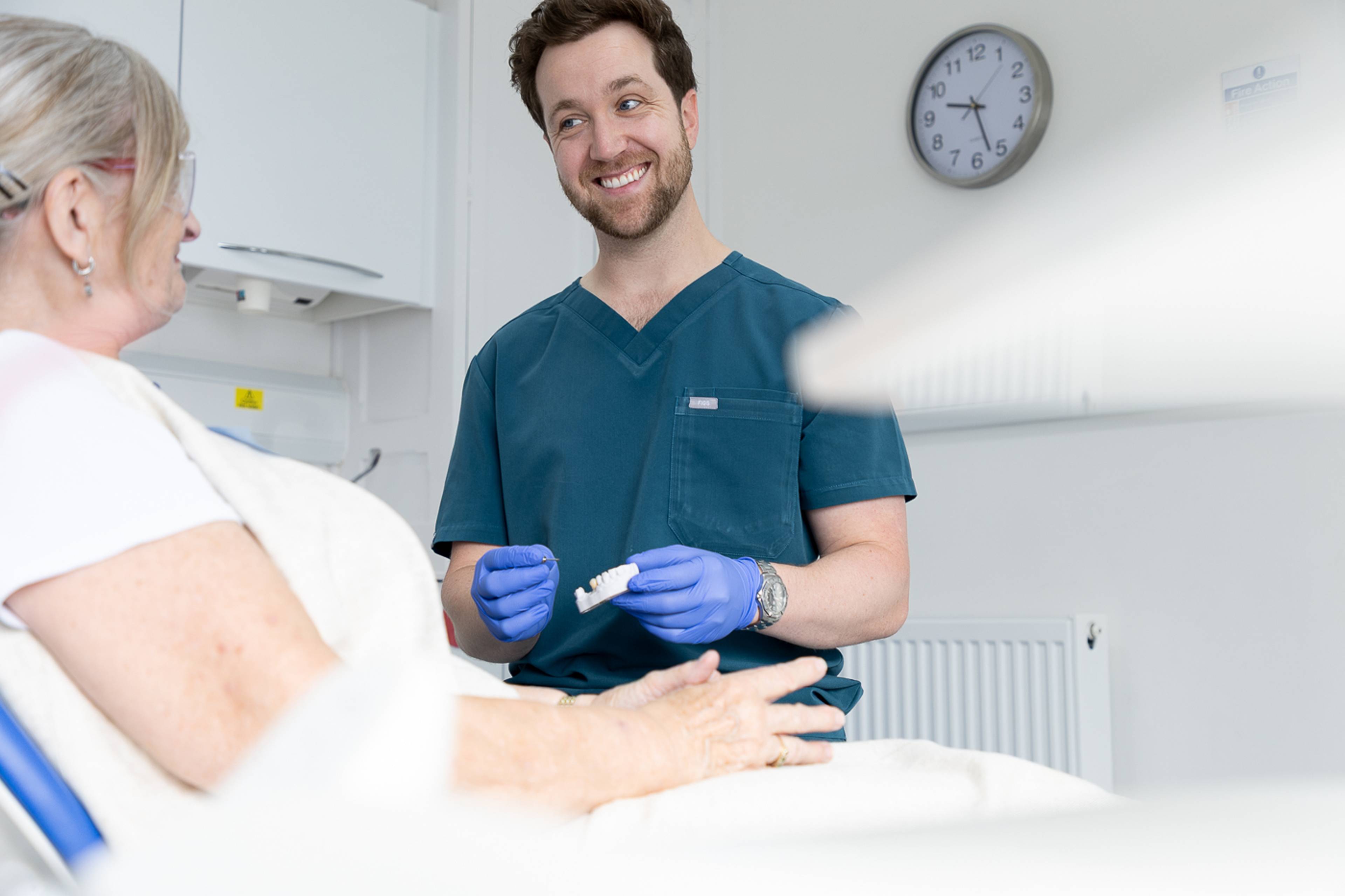 Tom Mann speaking to a patient