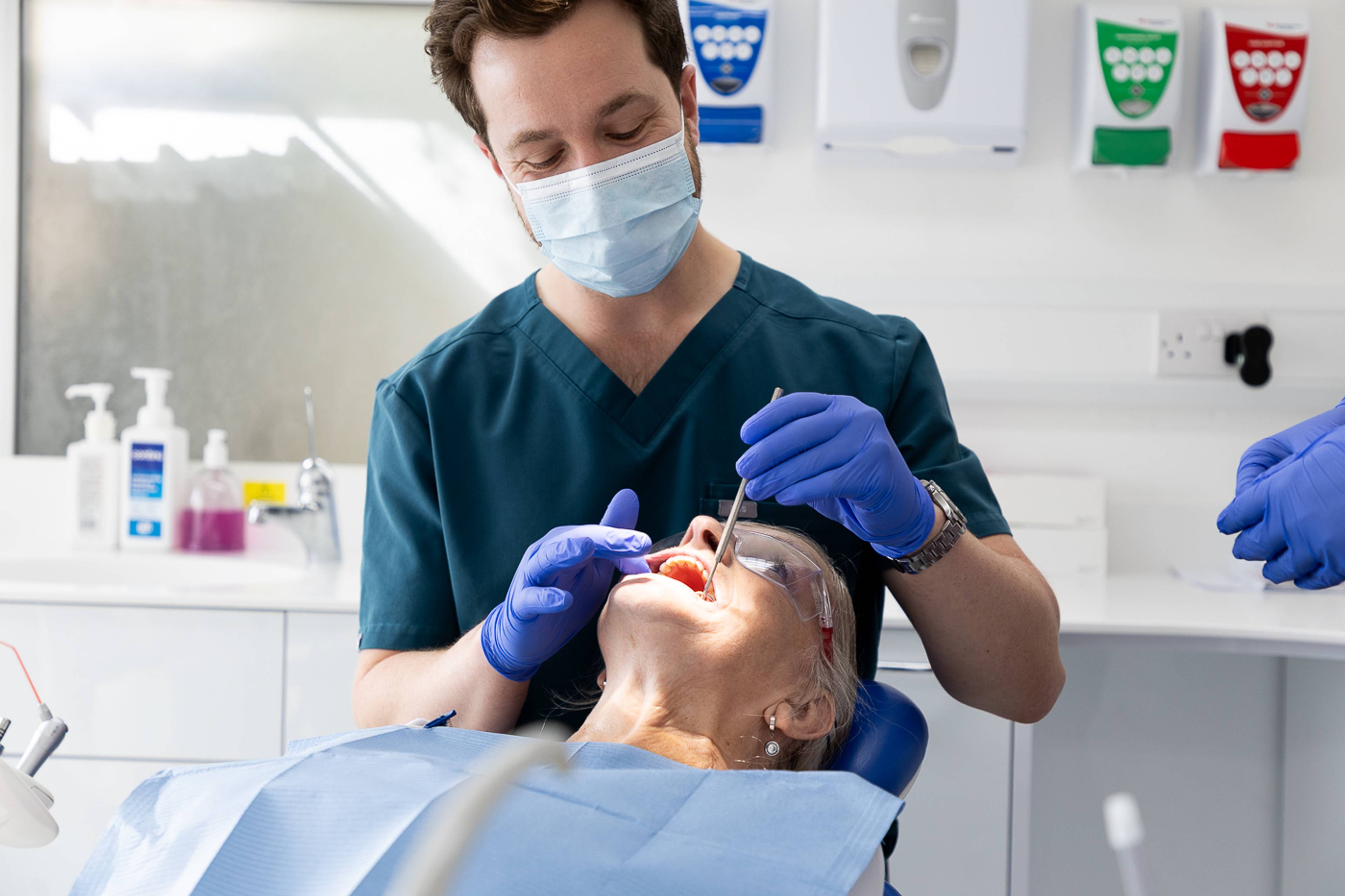 Tom Mann gives a patient a filling