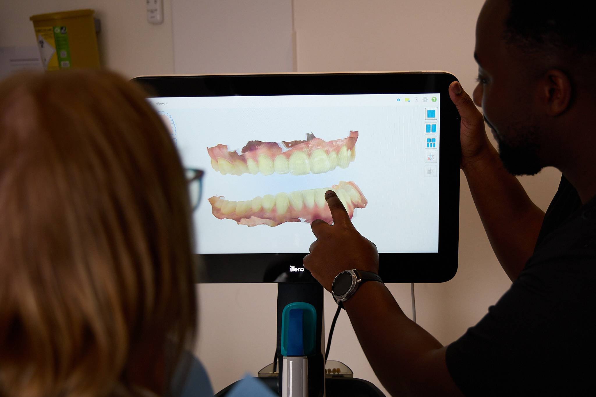 Michael Anaman showing a smile makeover to a patient