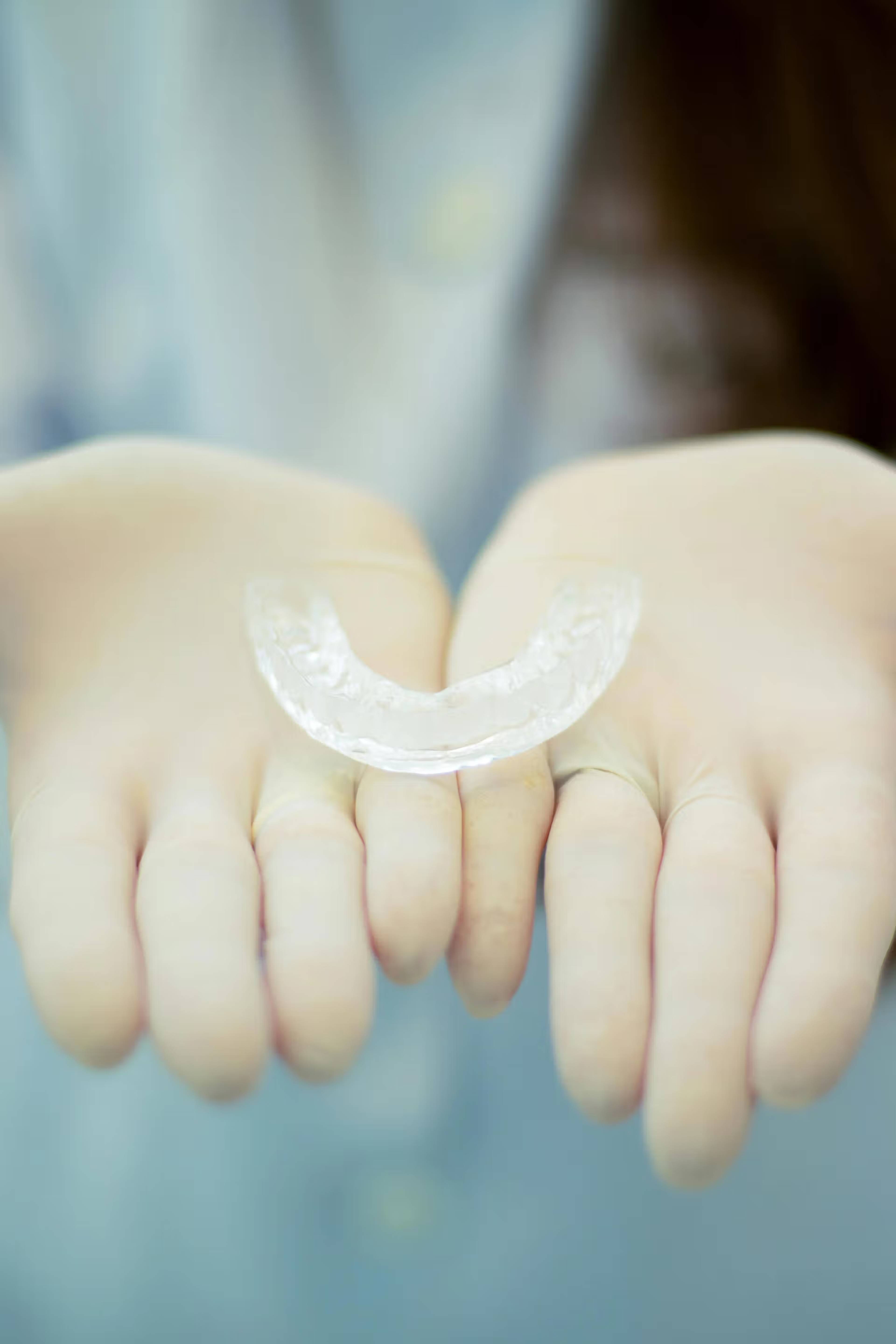 A stock photo of someone holding a mouth guard