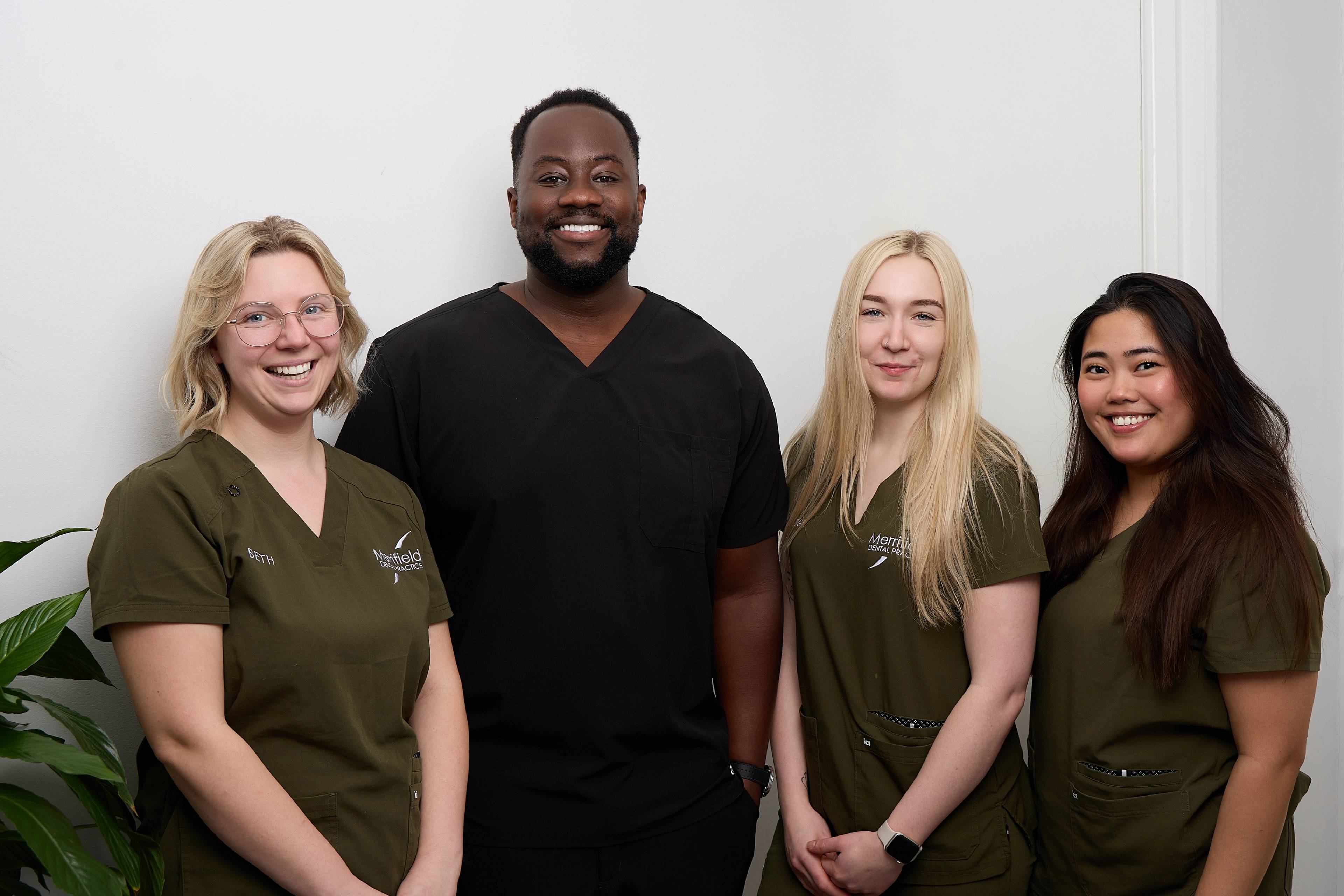 Michael Anaman standing with three dental nurses