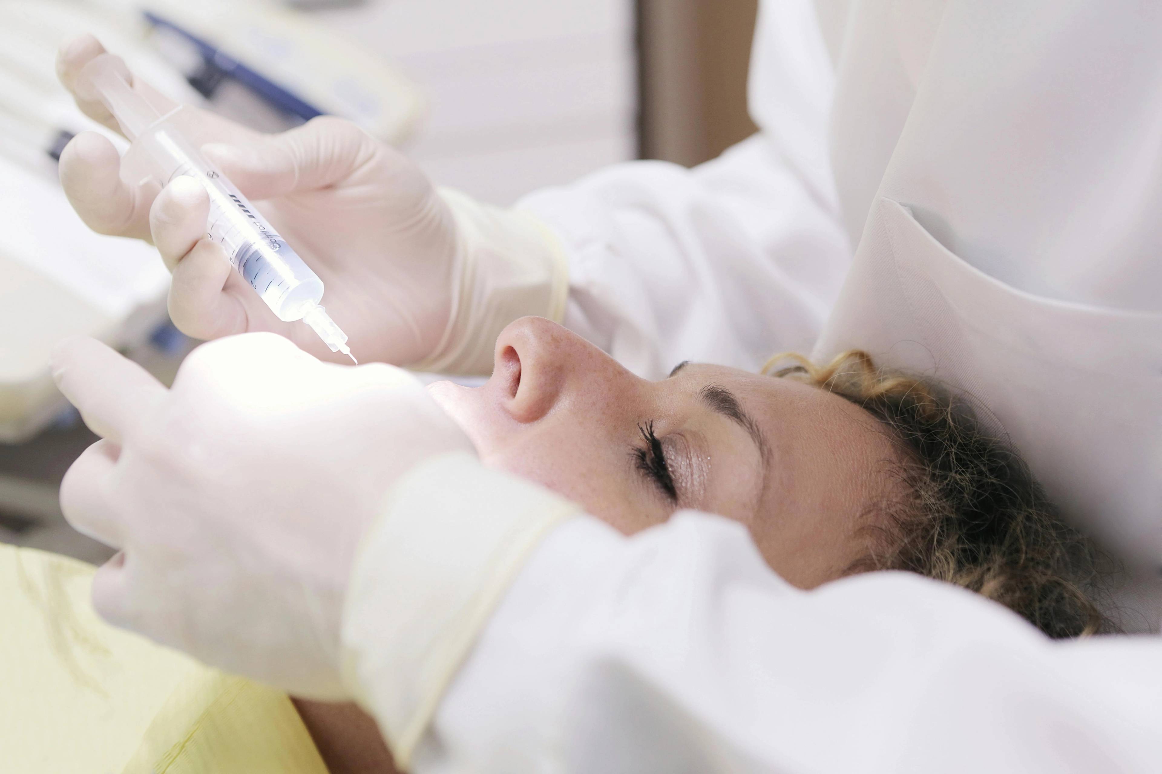 Stock photo of a woman receiving an injection in her jaw