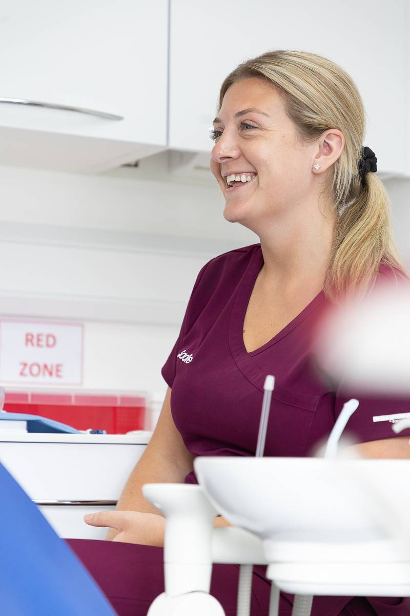 Dental nurse Sadie laughing with a patient who is out of frame