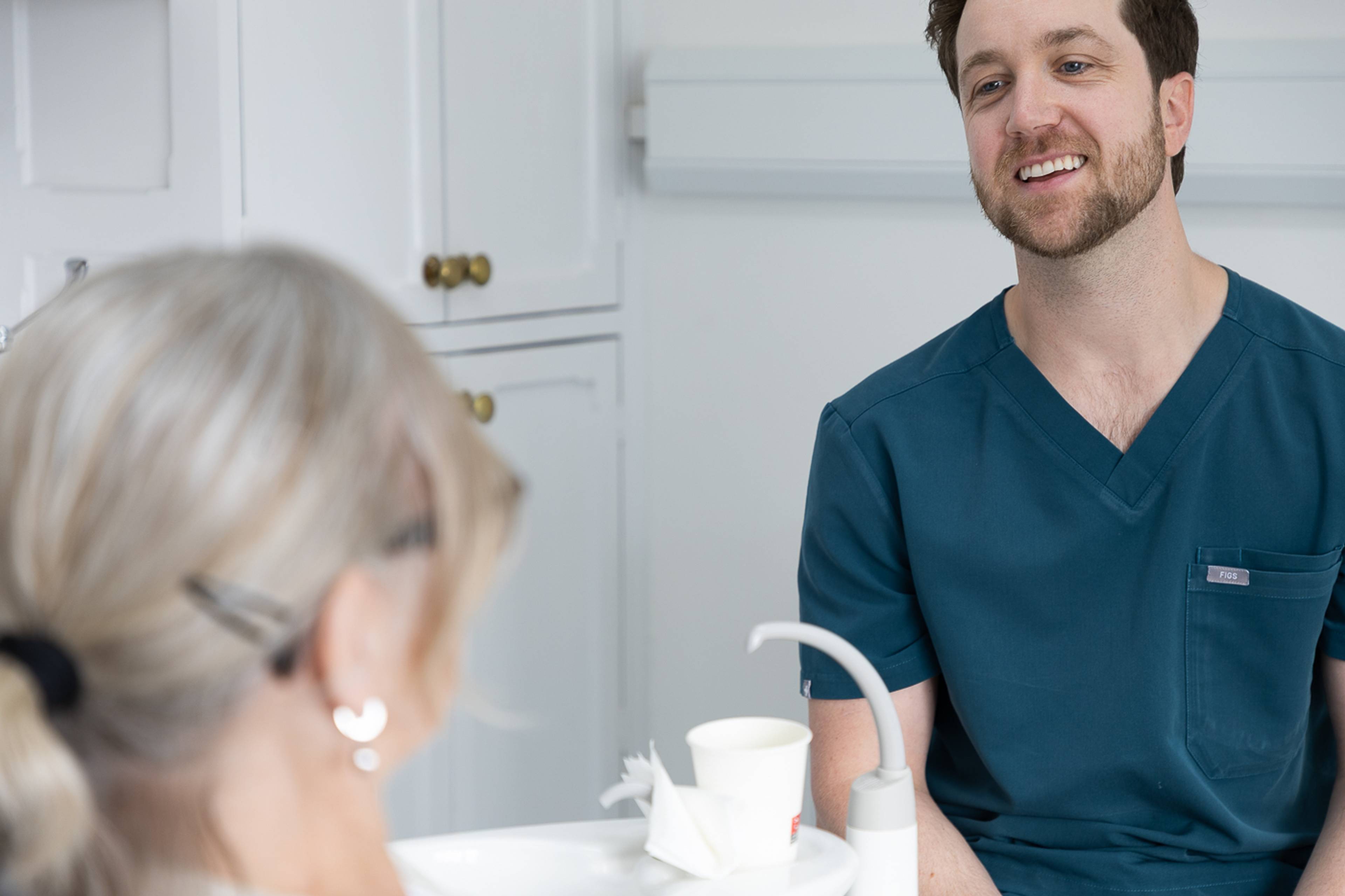 Tom Mann speaking with a patient