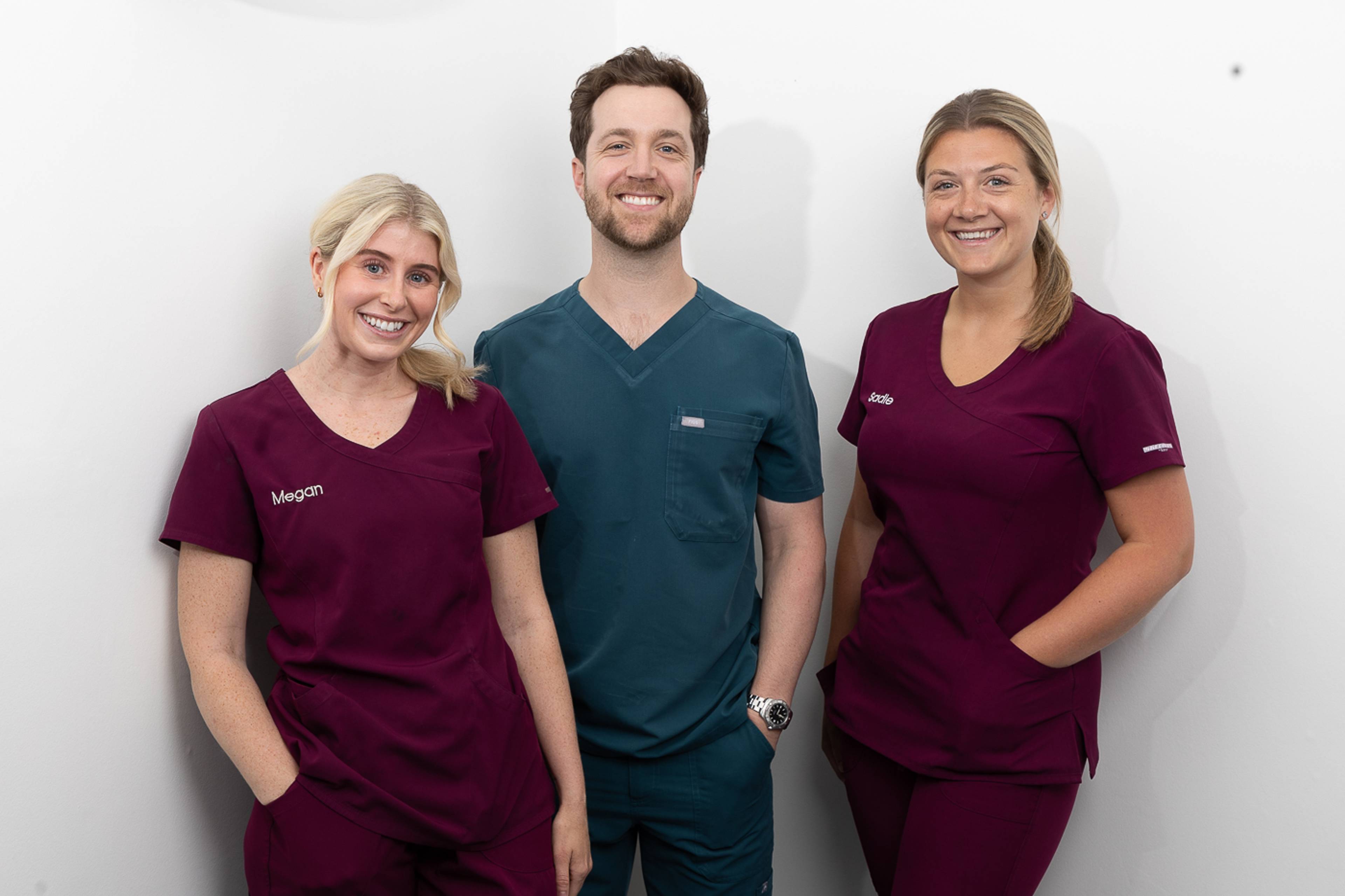 Tom Mann and two dental nurses smiling