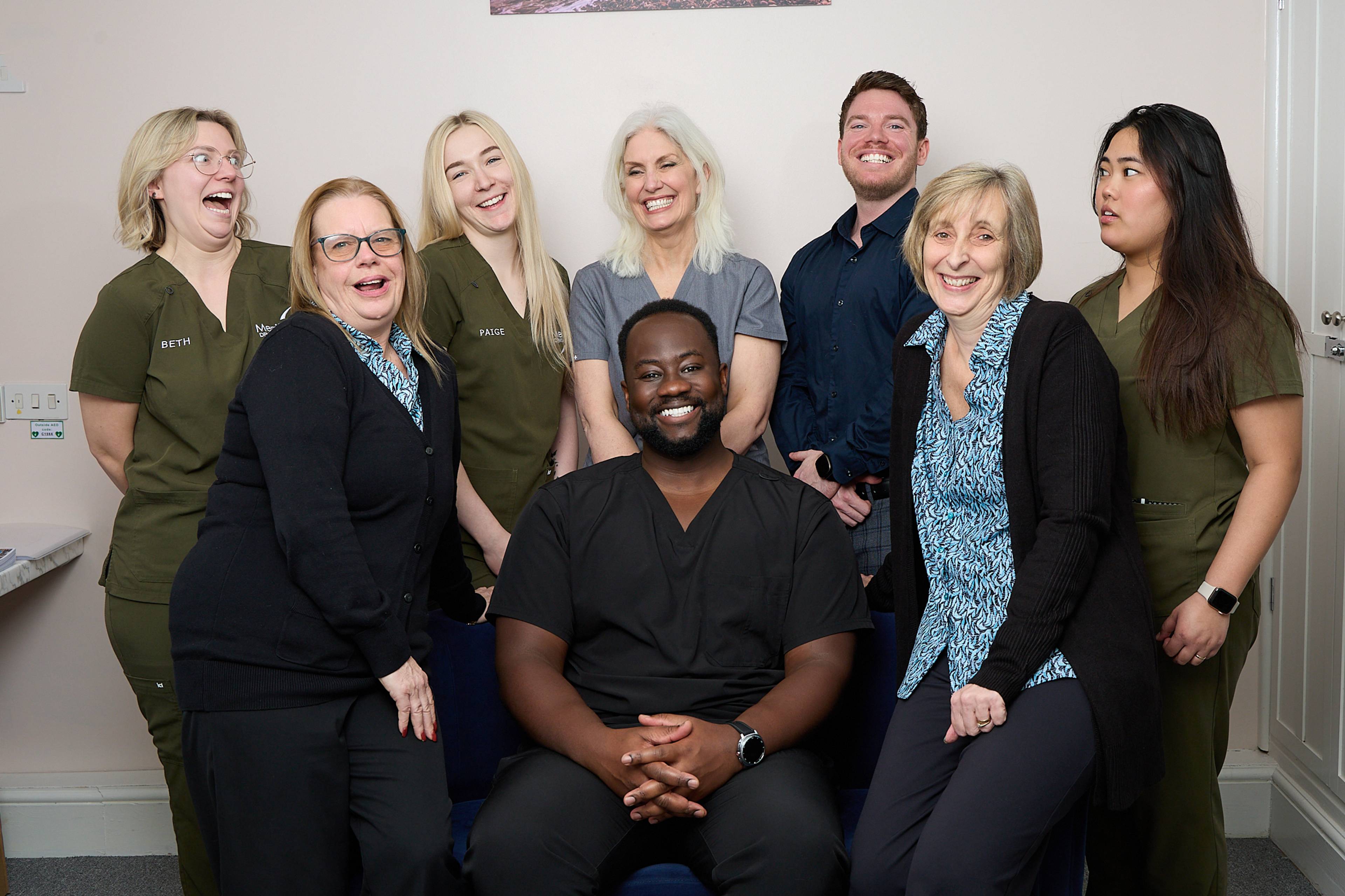 The team all smiling with Michael Anaman