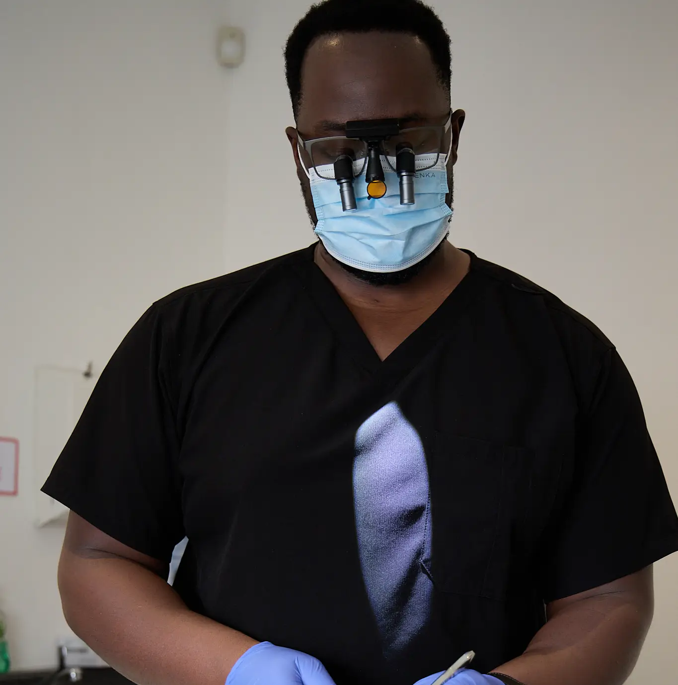 Michael Anaman inspecting a patient's gums