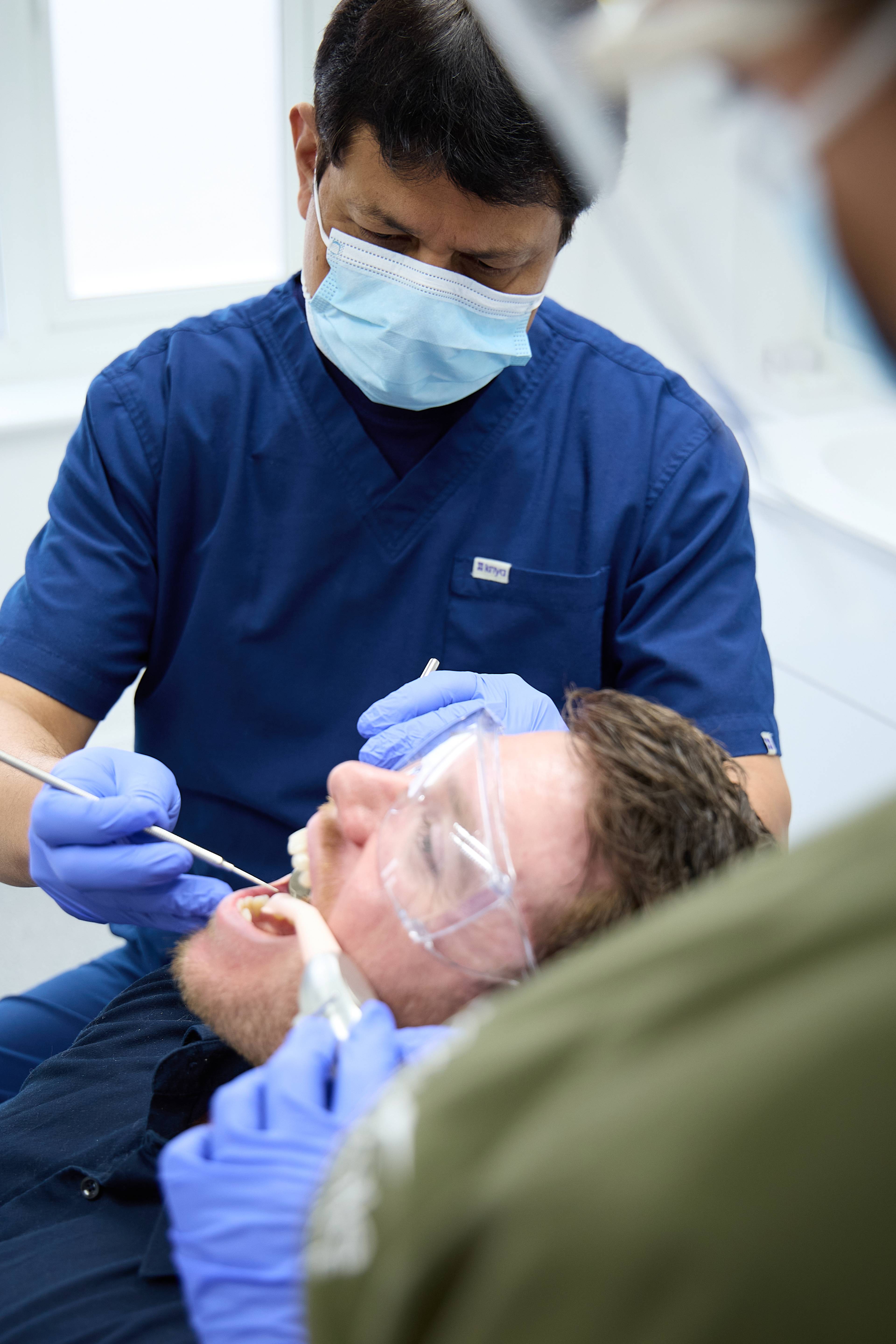 Rajesh Kumar working on a patient