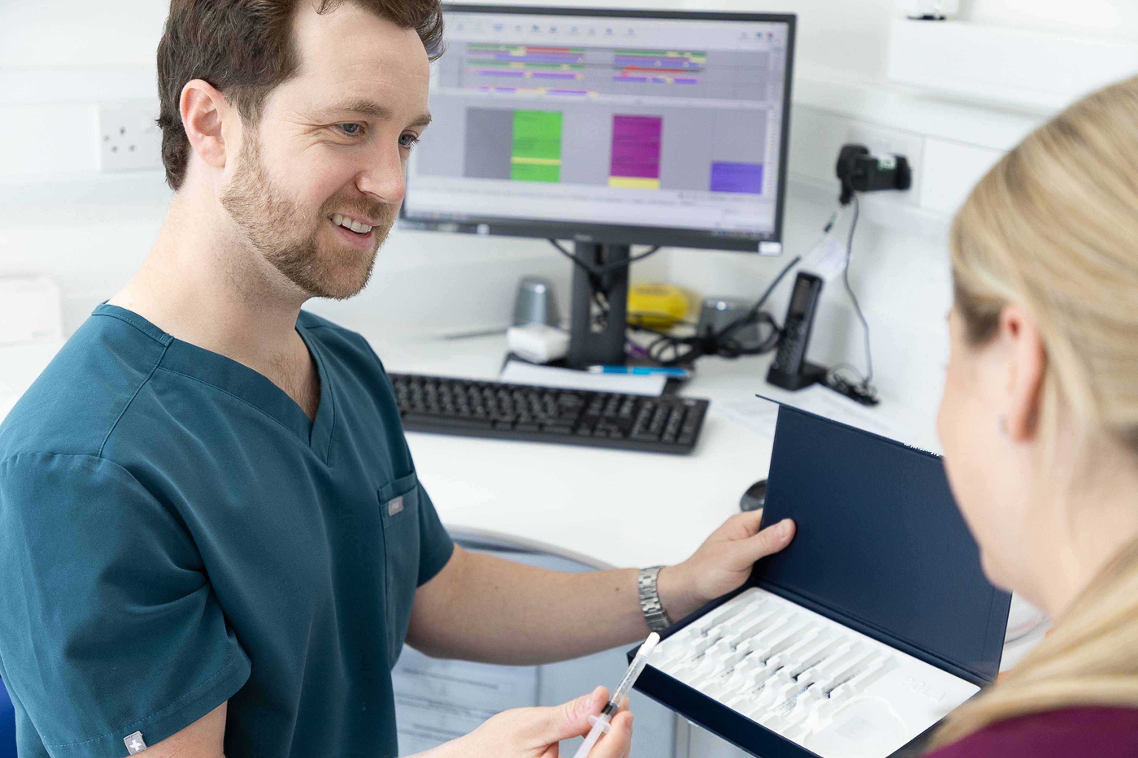 Tom Mann speaking to a patient