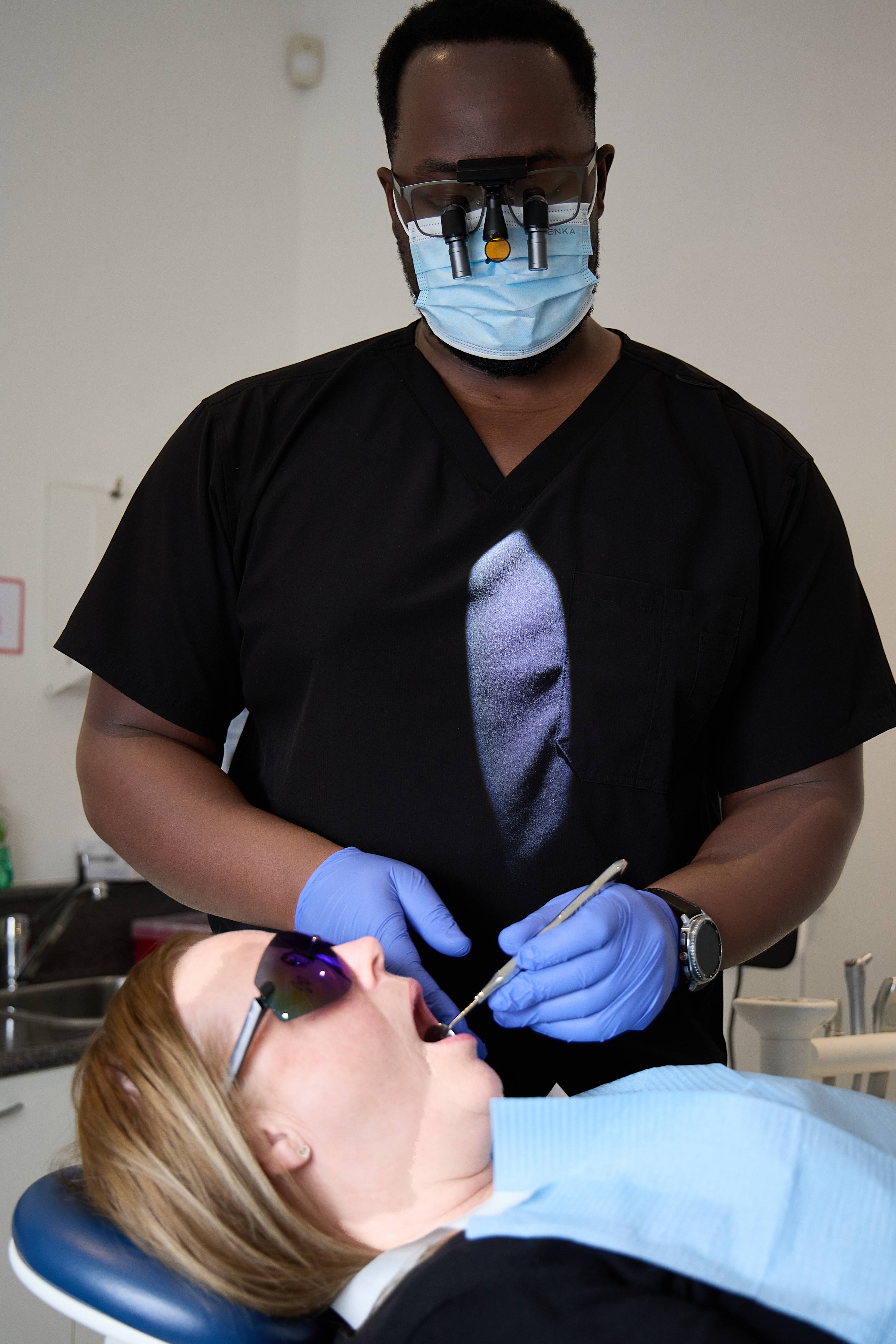 Michael Anaman gives a dental check-up to a patient