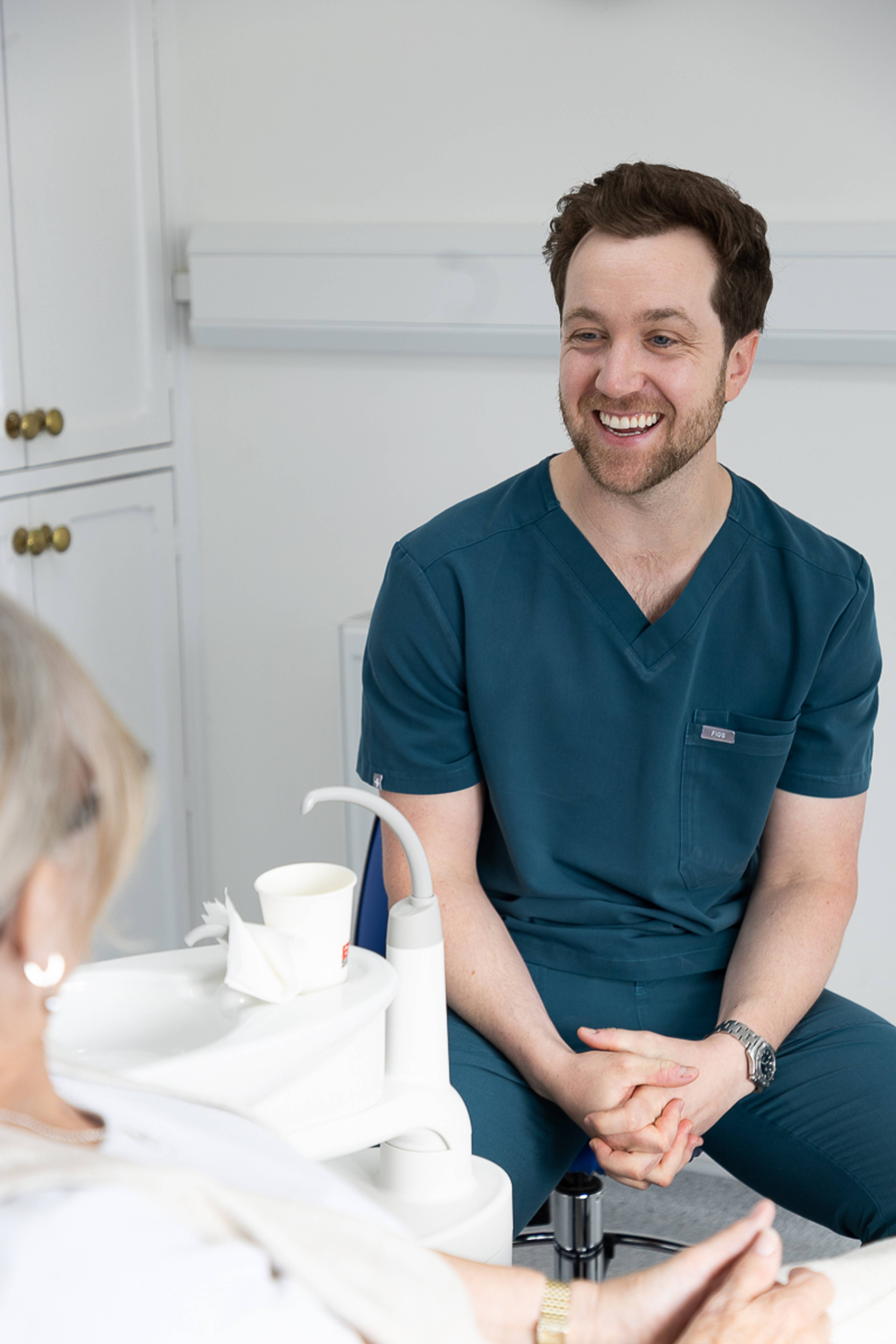 Tom Mann laughing with a client
