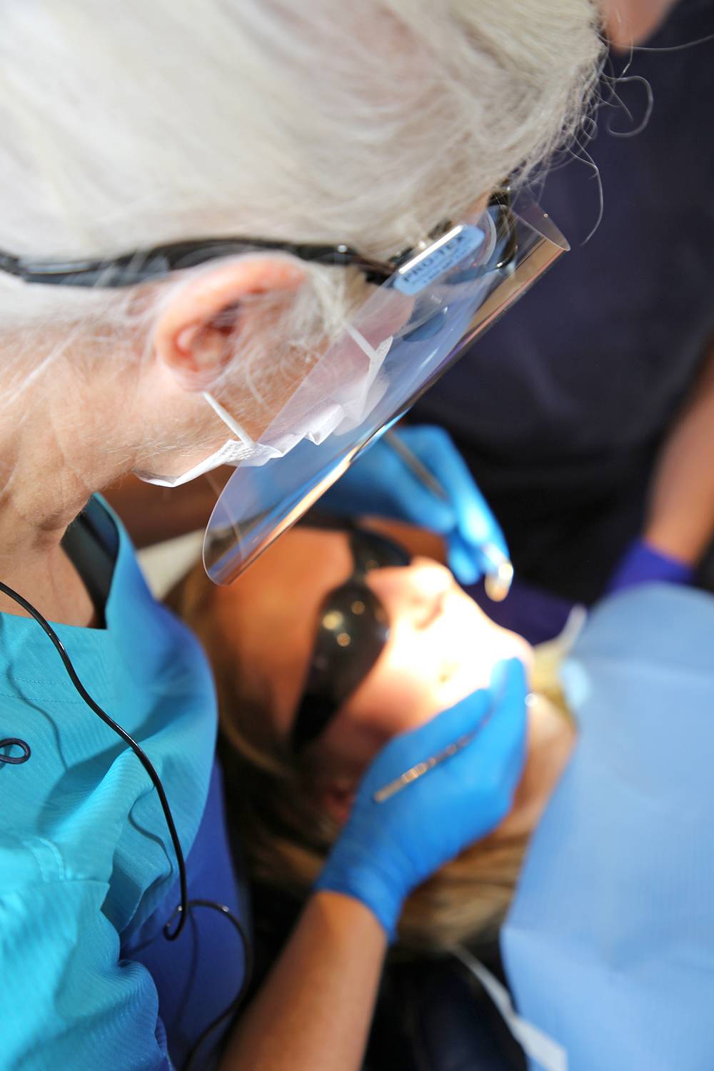 Hygienist and facial aesthetician Cathy Barber examining a patient