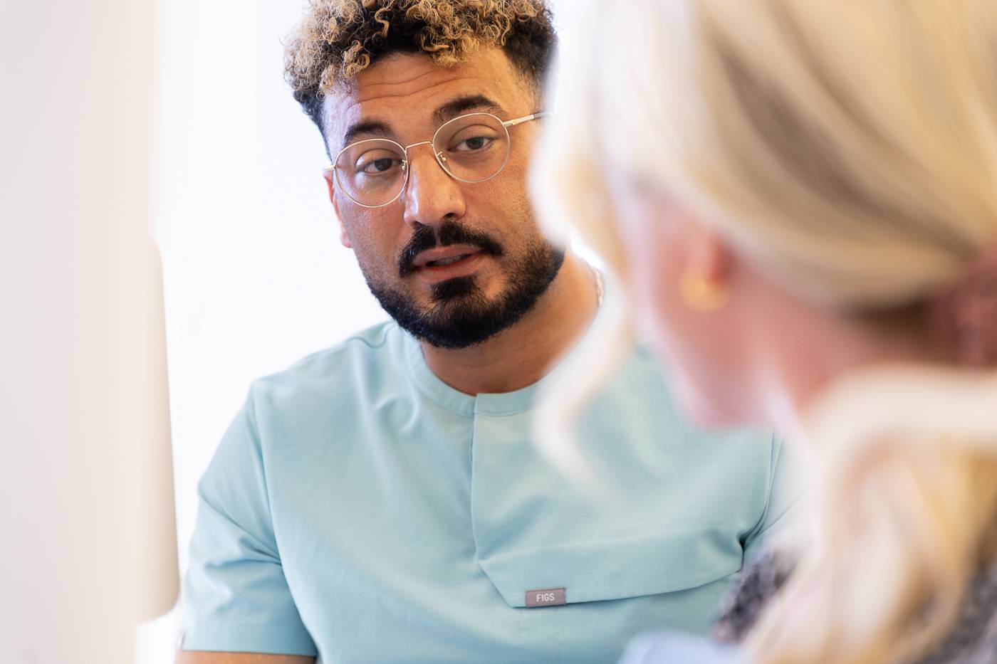 Tariq Abolsoud speaking to a patient