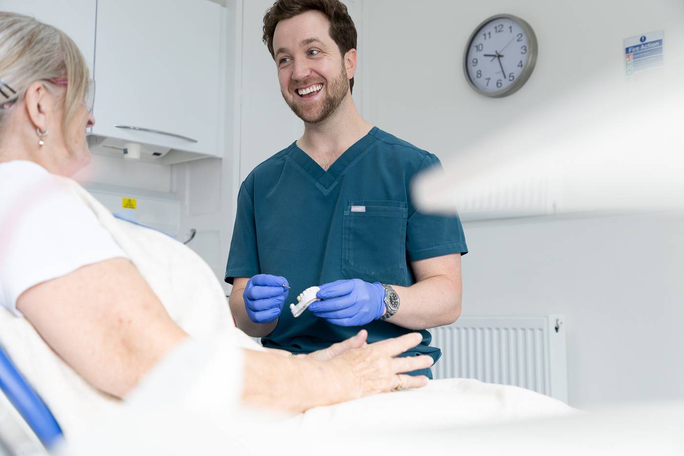 Tom Mann speaking to a patient