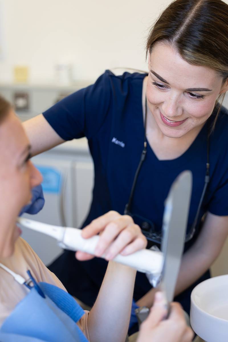 Dental hygienist Kerrie showing a patient proper tooth brushing technique