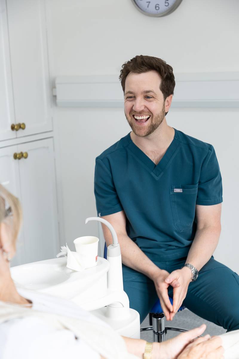 Tom Mann laughing with a patient
