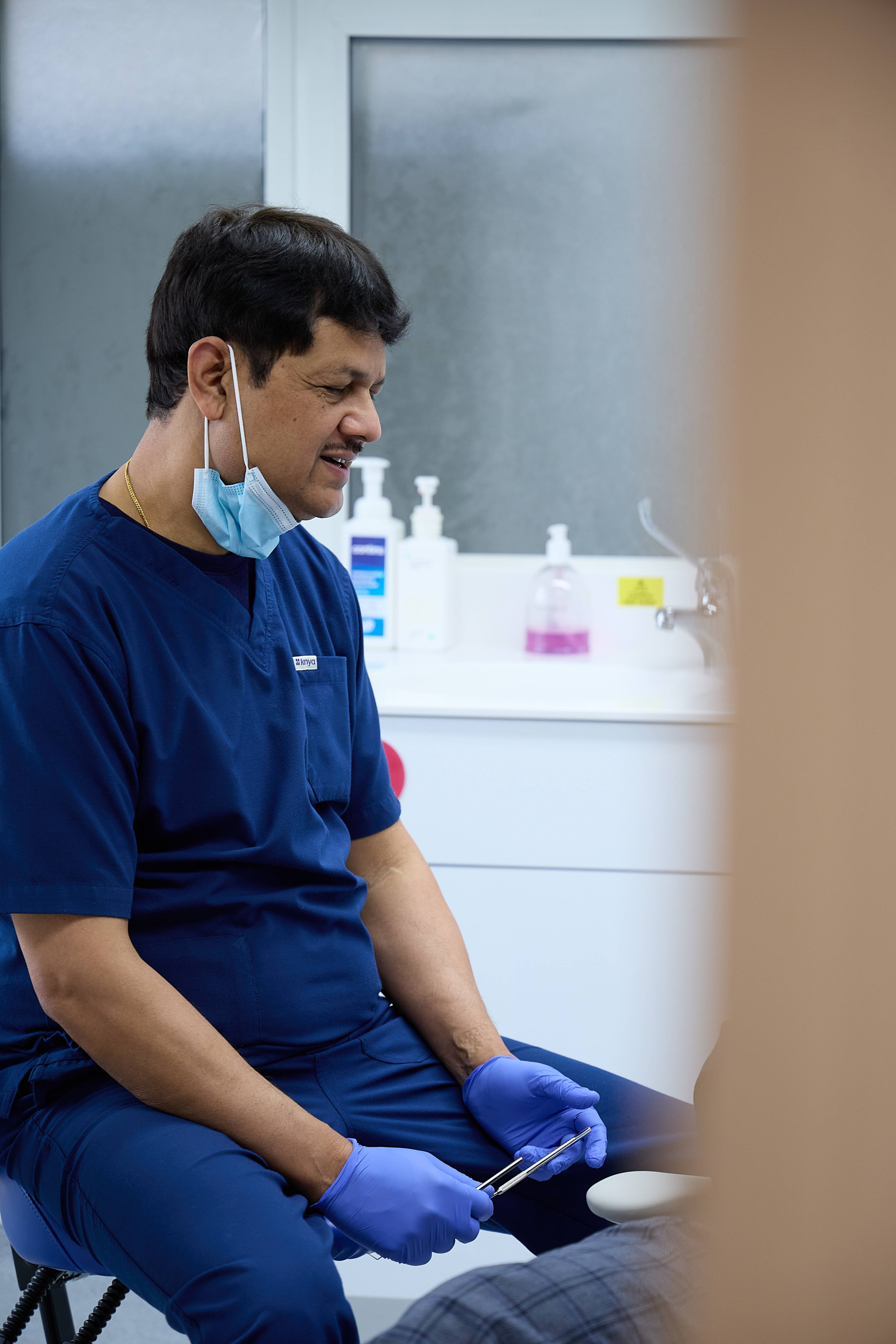 Rajesh Kumar speaking to a patient who is outside the shot of the camera