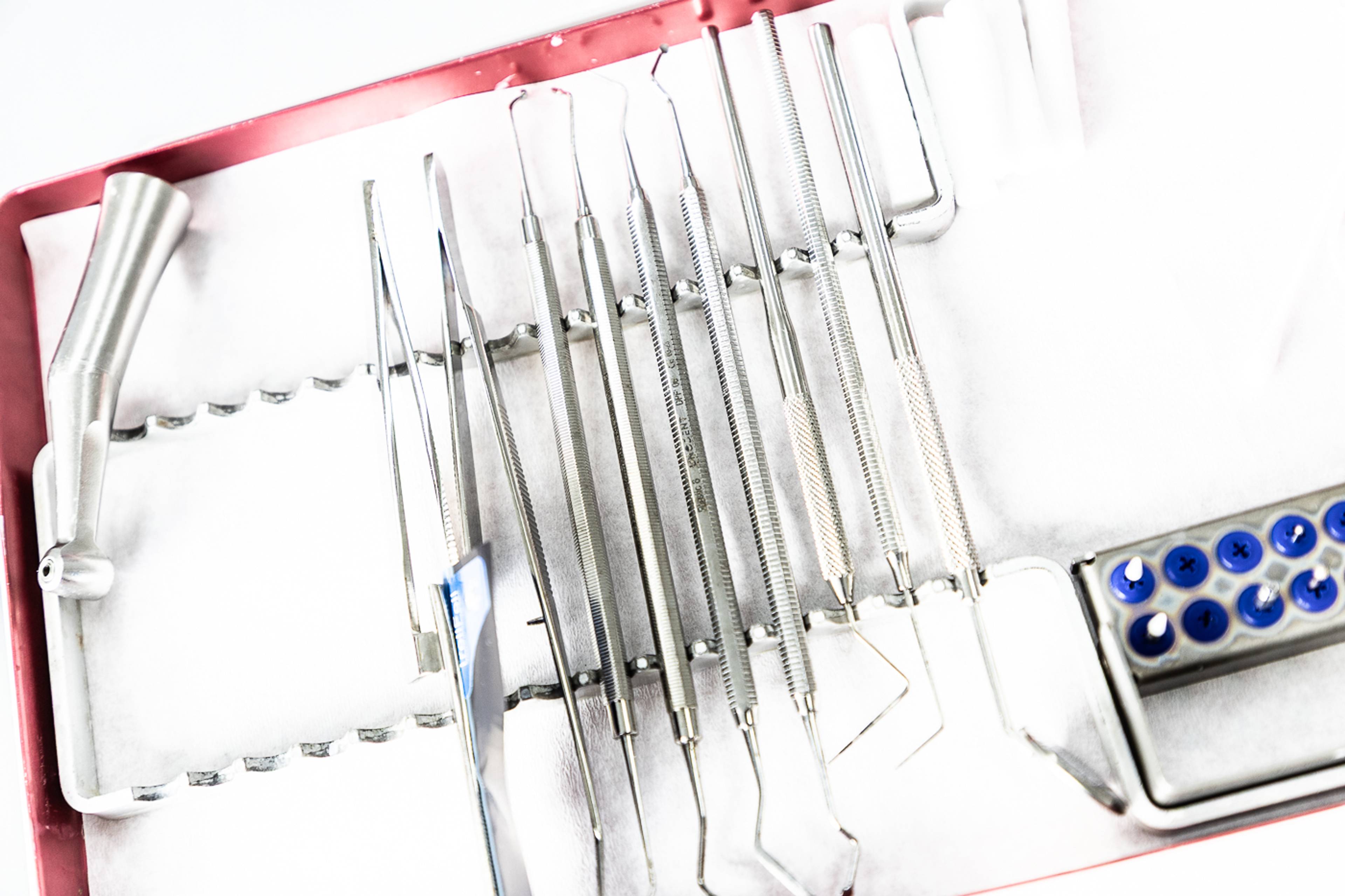 Dental instruments lined up on a treatment table