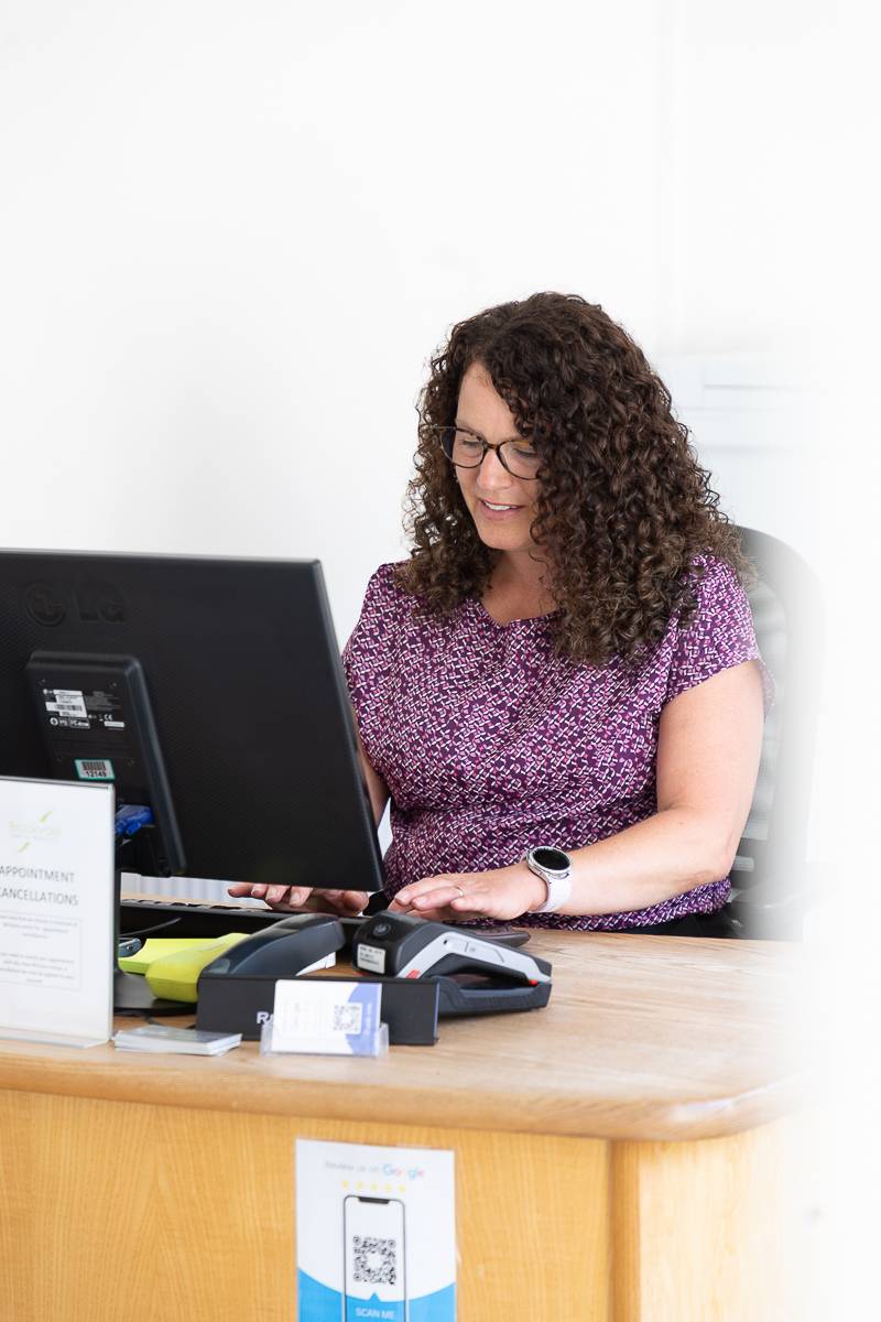 A receptionist sitting at a desk and working