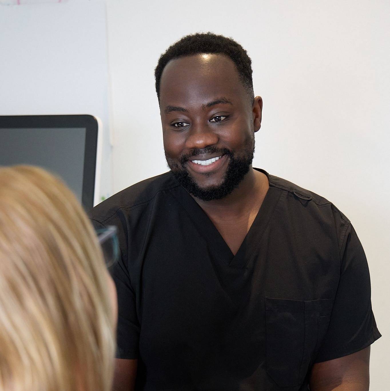 Michael Anaman speaking with a nervous patient