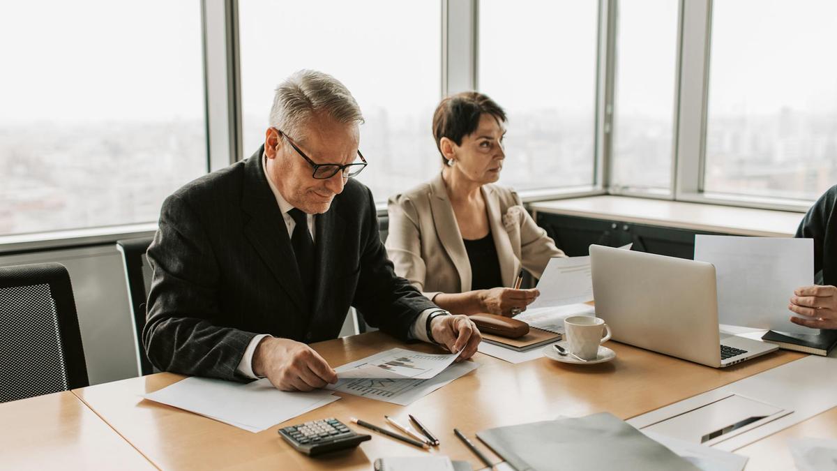Corporate meeting with professionals discussing documents in a modern office.