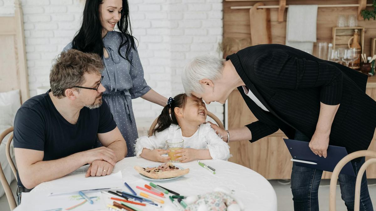 A happy family with a social worker in a warm indoor setting, discussing child welfare.