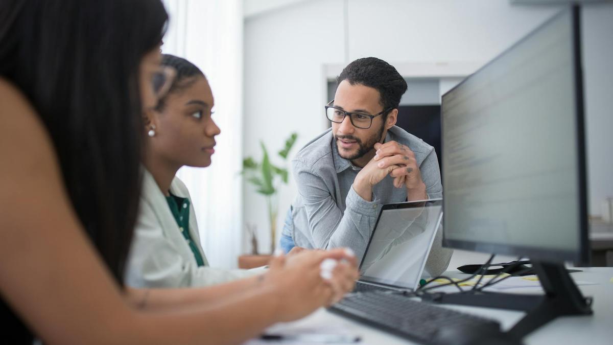 Diverse team engaging in collaborative work in a contemporary office environment.