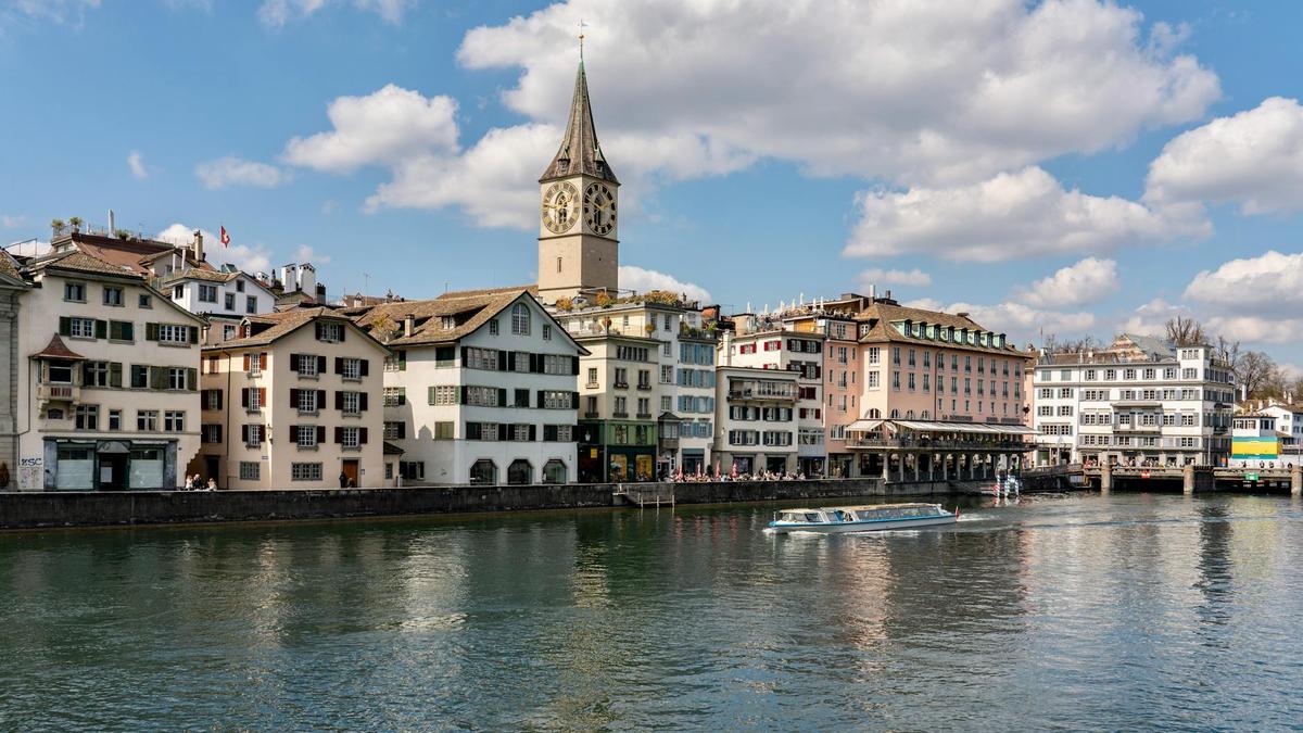Scenic view of St. Peter's Church by the Limmat River in Zurich, Switzerland.
