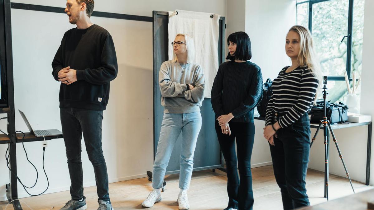 A diverse team in a modern office setting during a professional presentation.