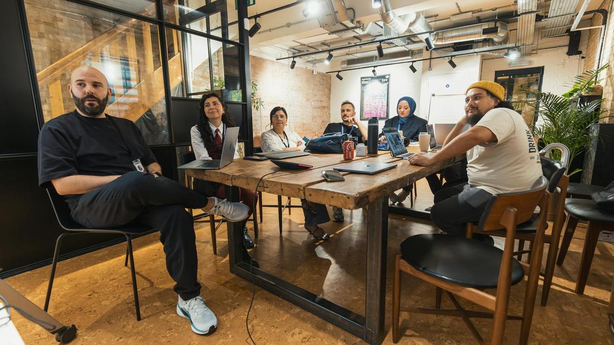 Diverse team engaged in a collaborative meeting in a contemporary office space.