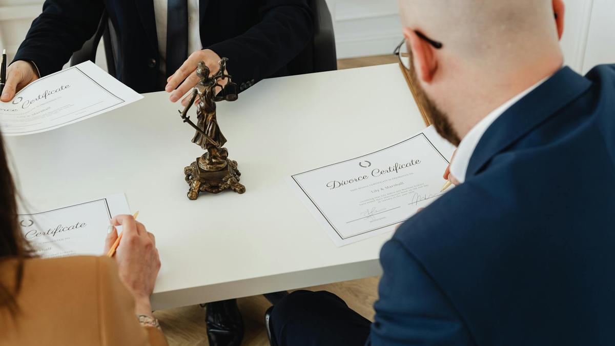 A professional setting with a focus on signing divorce documents in an office environment.