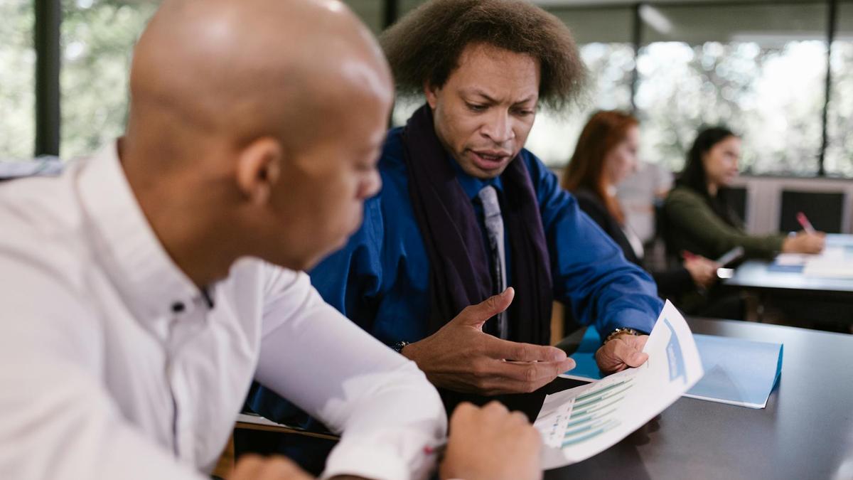 A team of professionals collaborating on business reports in an office setting.