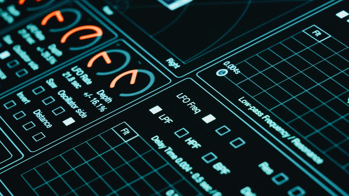 Close-up of a digital interface showcasing futuristic graphs and data analytics in low light.
