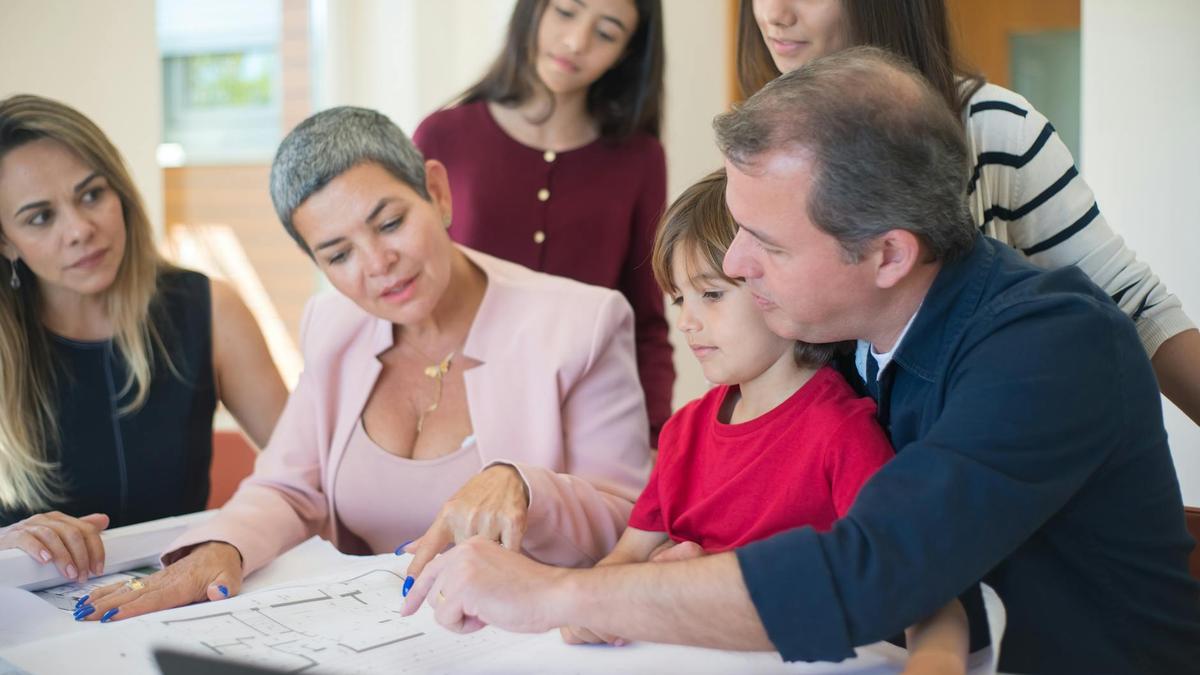 Family meeting with realtor to discuss house plans, emphasizing real estate decision-making.