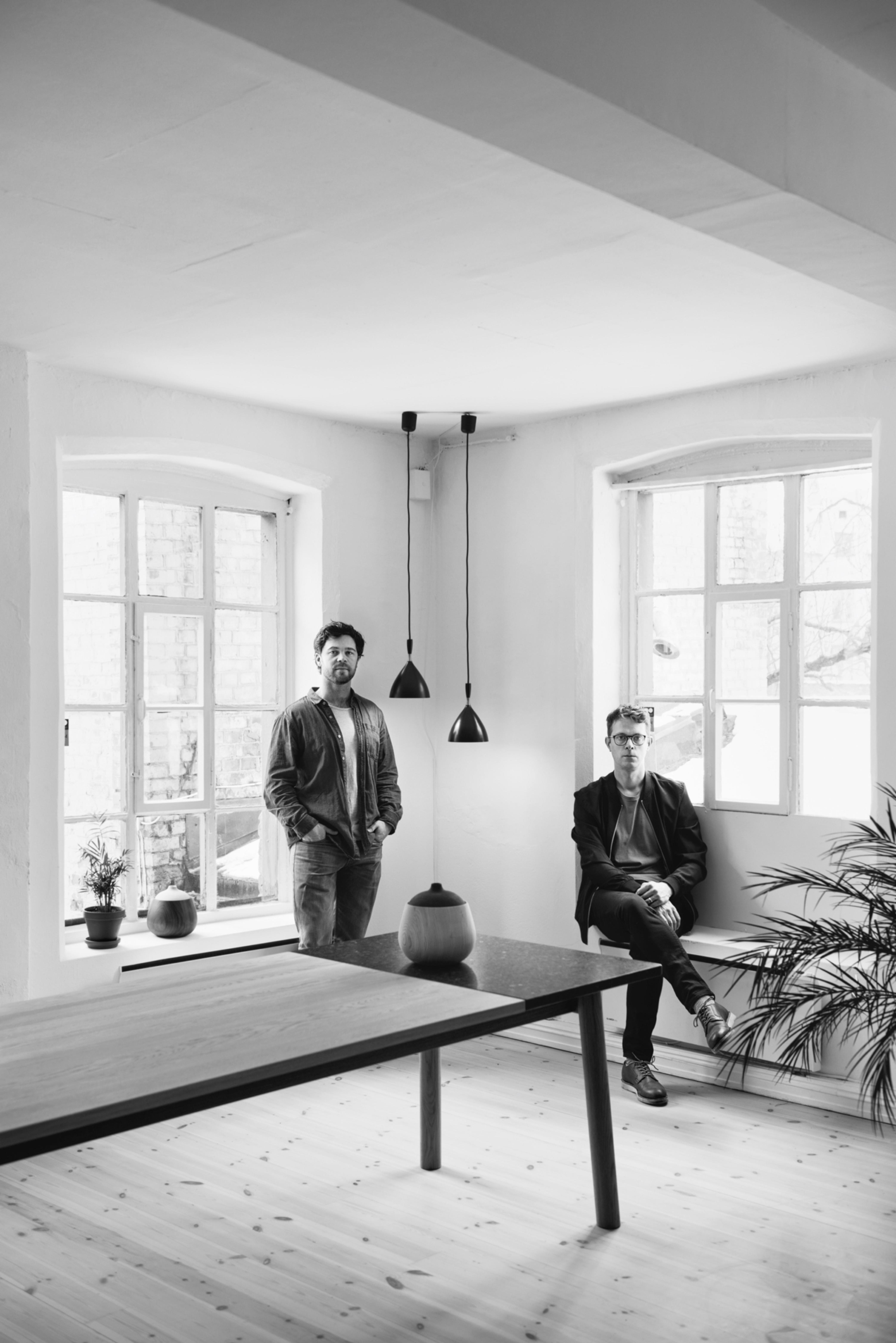 Jenkins & Uhnger in a bright room with a dining table and two black pendant lamps