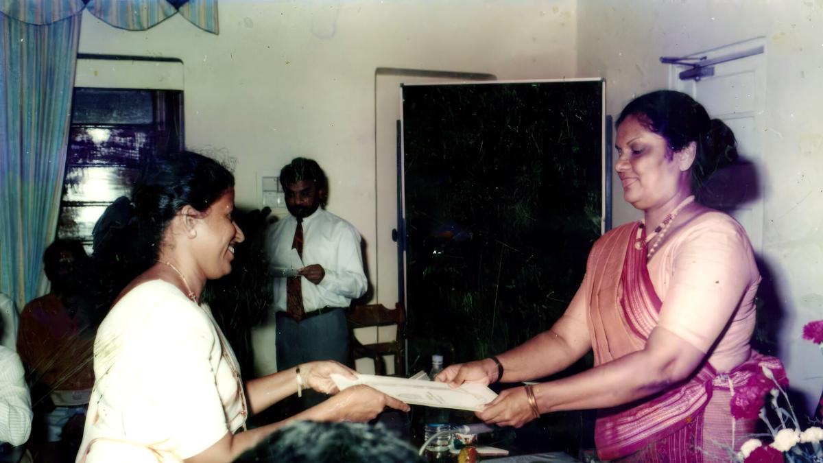 An early photograph: Darshani Chandrasena receives a certificate across a table