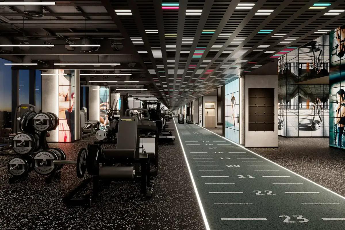 1. Modern gym interior with workout equipment, fitness area, and digital screens showcasing fitness routines and healthy lifestyle tips.