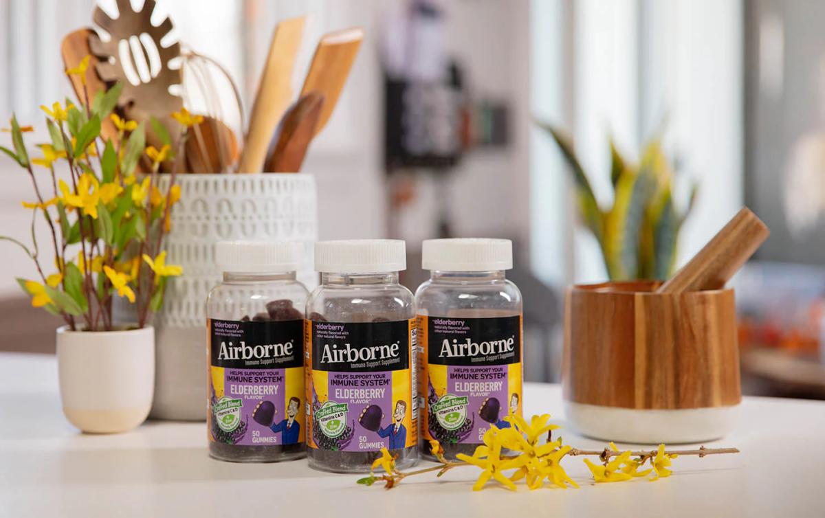 Airborne Elderberry immune support gummy bottles on a kitchen counter.