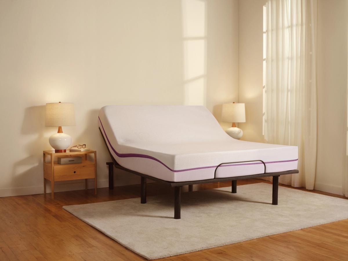 Purple mattress on an adjustable base with the head raised in a sunlit bedroom