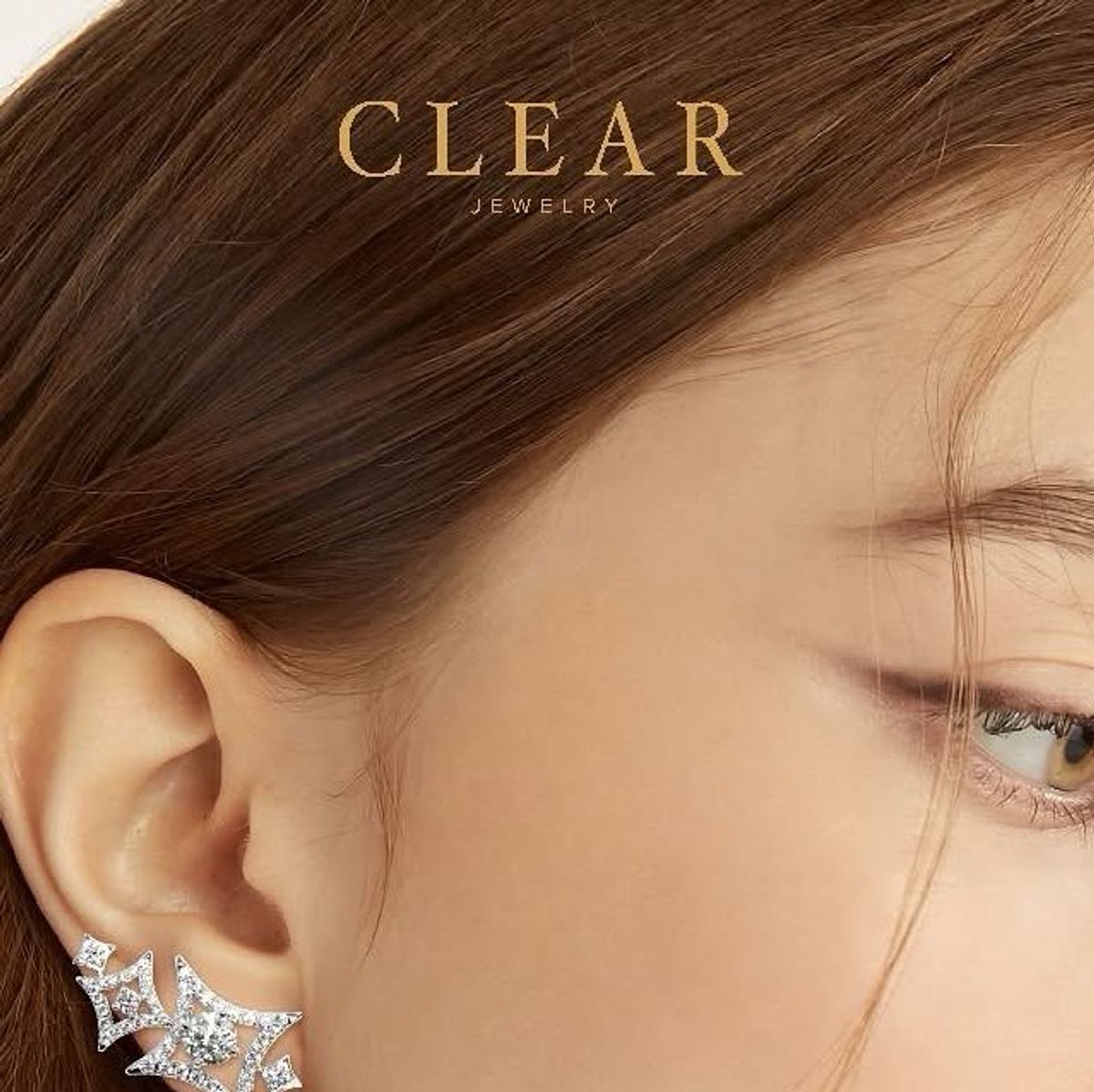 Close-up of a model ear with a pavé diamond star ear climber.