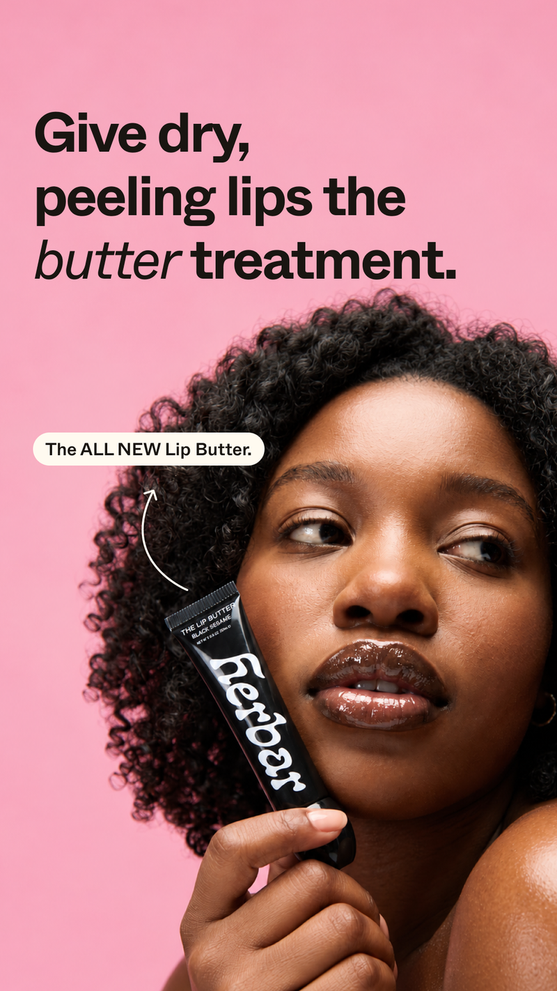 Herbar static ad shows a woman with glossy lips holding a black Lip Butter tube to her cheek against a pink background. The headline reads “Give dry, peeling lips the butter treatment.” and a label points to “The ALL NEW Lip Butter.”