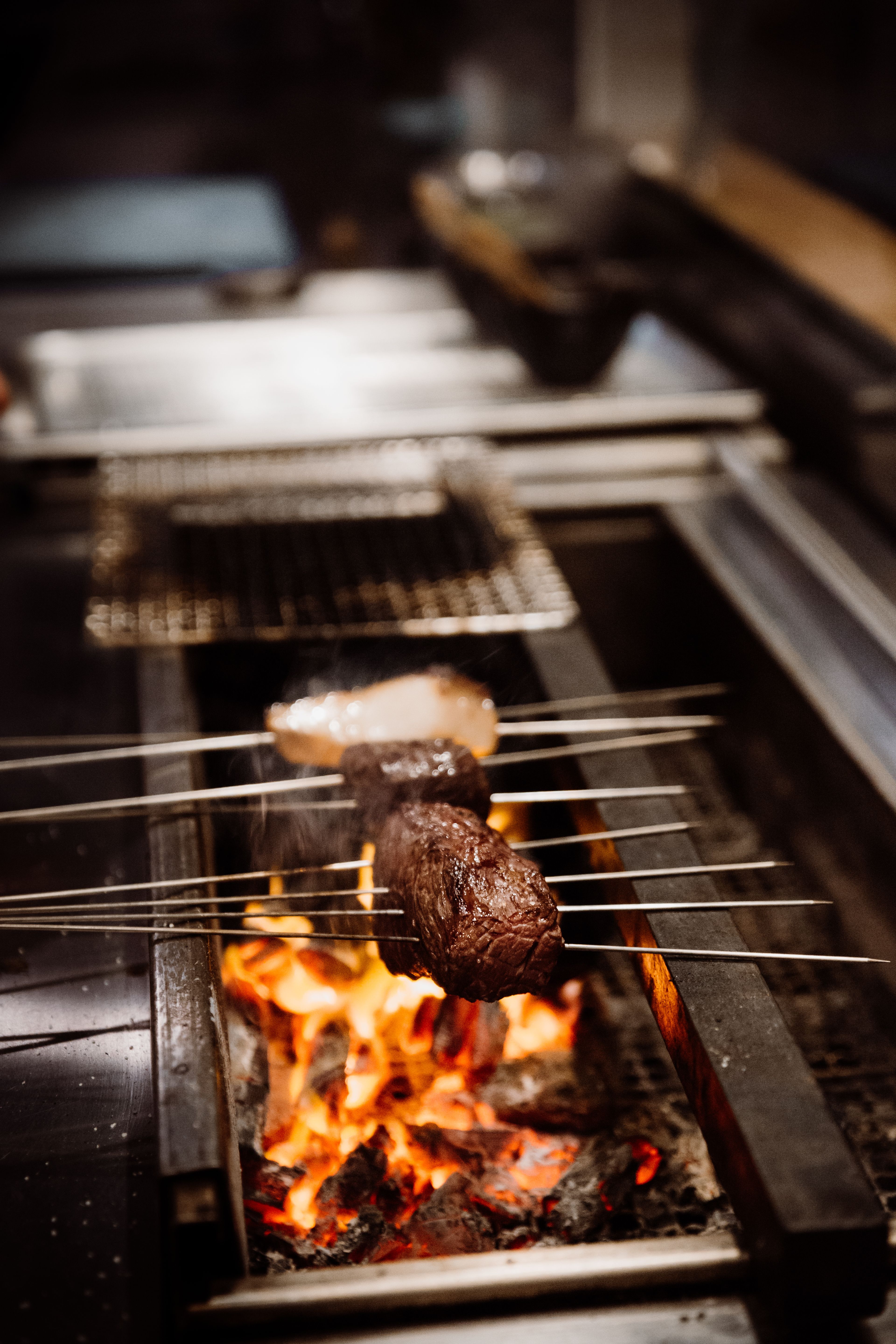 Meat being cooked over fire | Studio Hiller