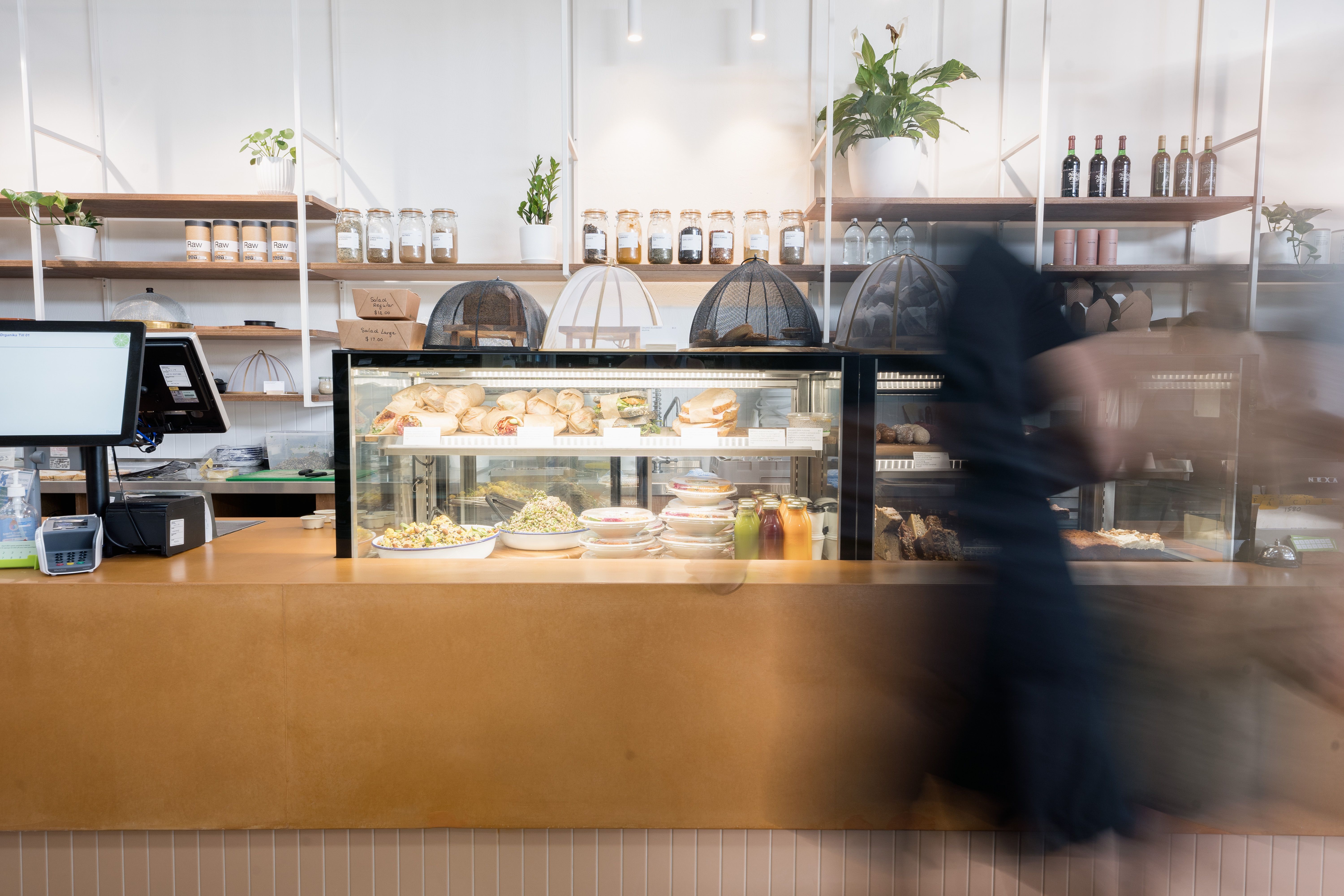 Cafe front counter and person | Studio Hiller