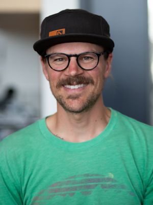 David Anhalt in glasses and a green t-shirt