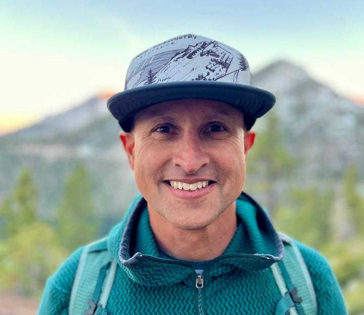 Rob Flesher smiling in a trucker cap