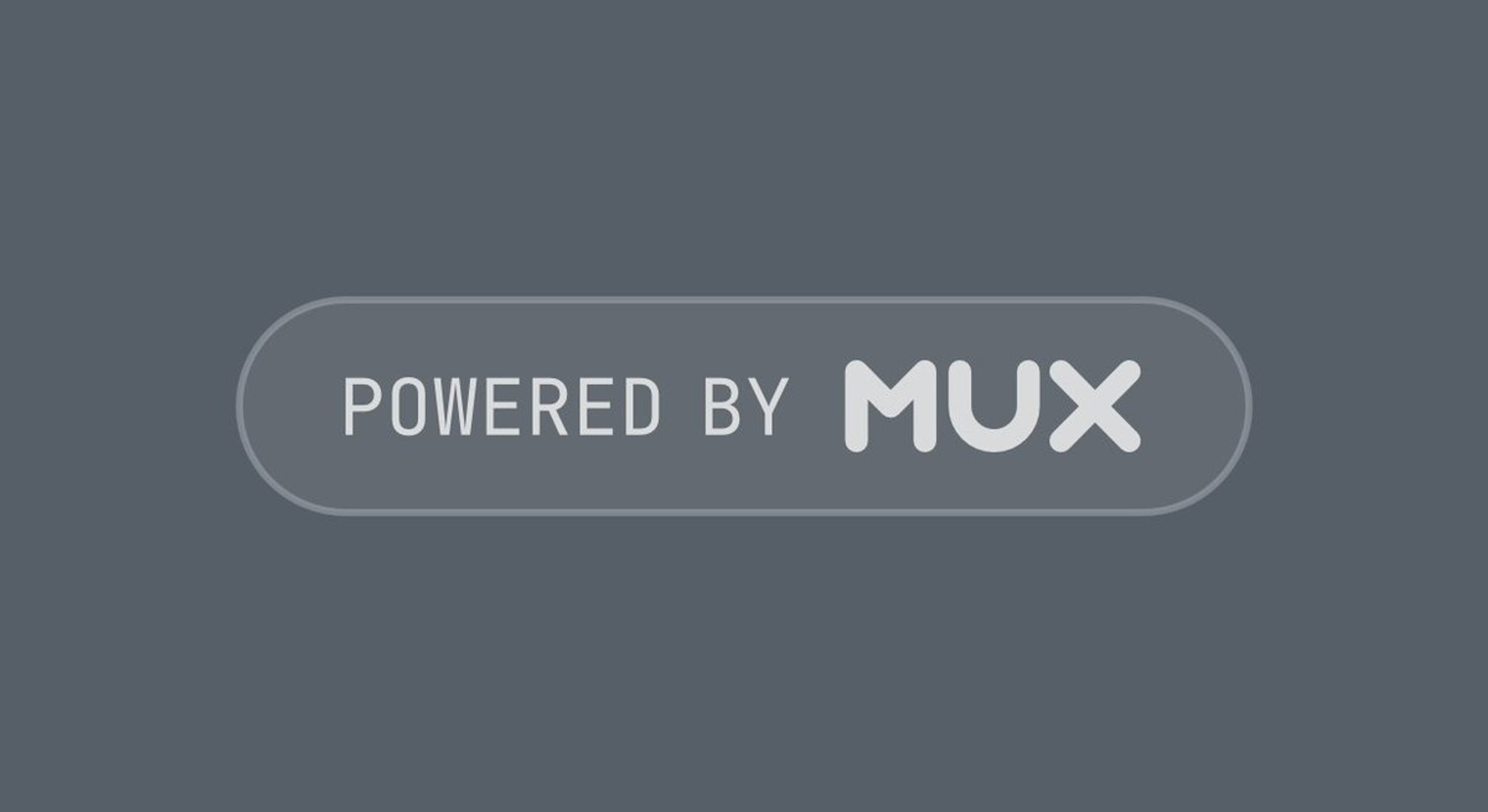 A dark gray rectangular badge with rounded corners that reads "Powered by Mux" in uppercase letters. The text is light gray, and the word "Mux" is bolder and slightly larger than the rest. The badge has a subtle outline, giving it a modern and sleek appearance.