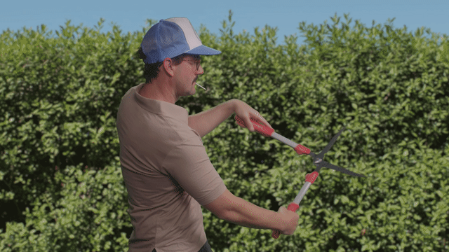 Gif of Mux co-founder Matt McClure shrugging his shoulders and pretending like he's clipping hedges